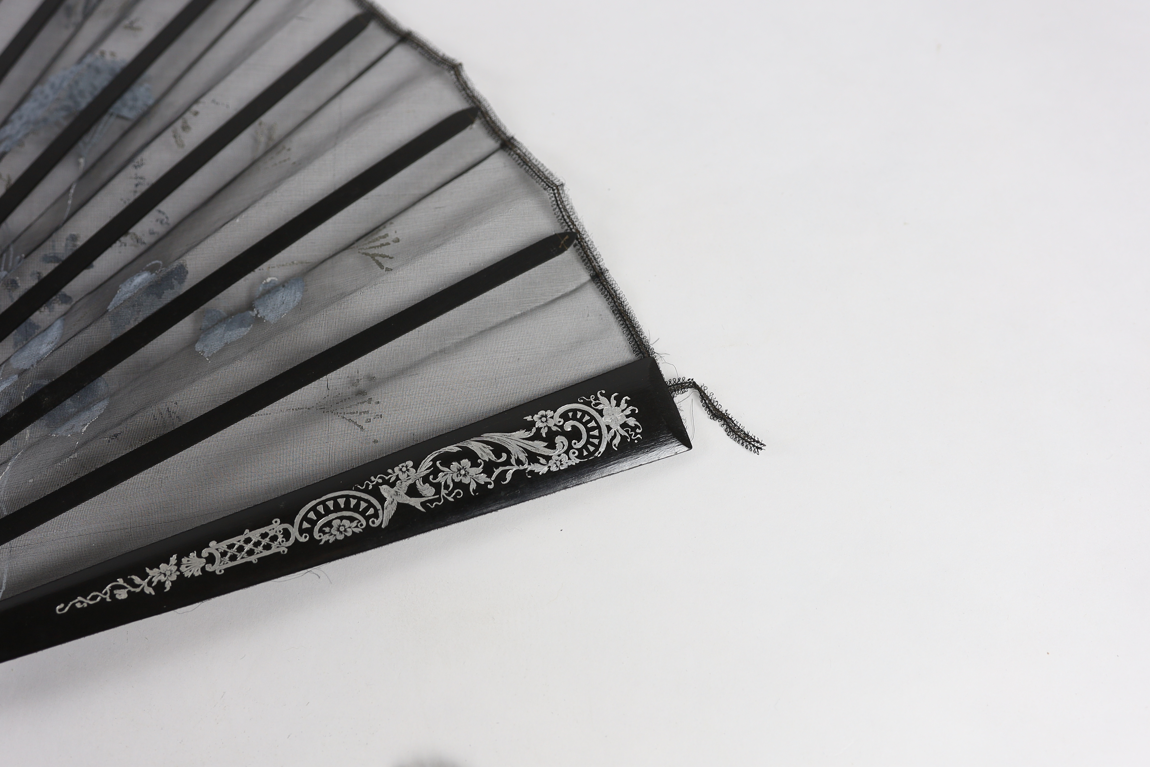 An Edwardian black silk and ornate sequin fan, a similar fan with carved ebony guards and a fine gauze fan with painted sprig and butterfly decoration (3)